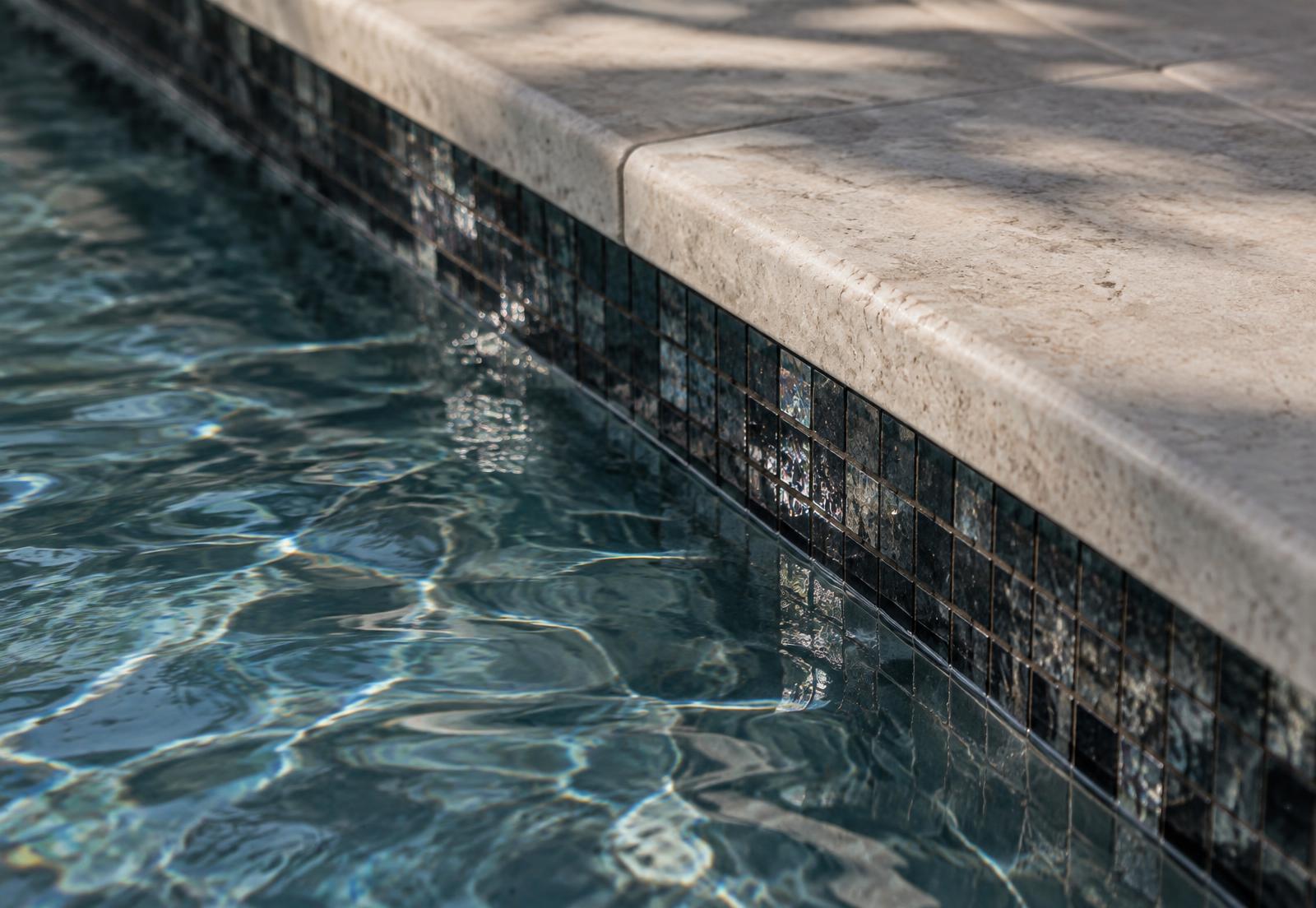 Waterline tile and coping detail after a remodel